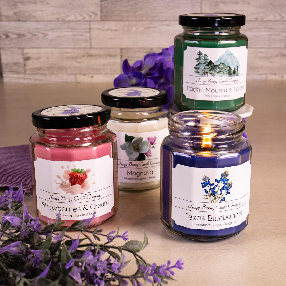 Assortment of Classic Collection Scented Candles including Texas Bluebonnet, Strawberries and Cream, Magnolia, and Pacific Mountain Forest.